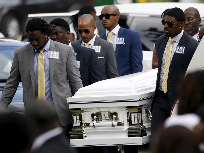 Individual lifting the casket